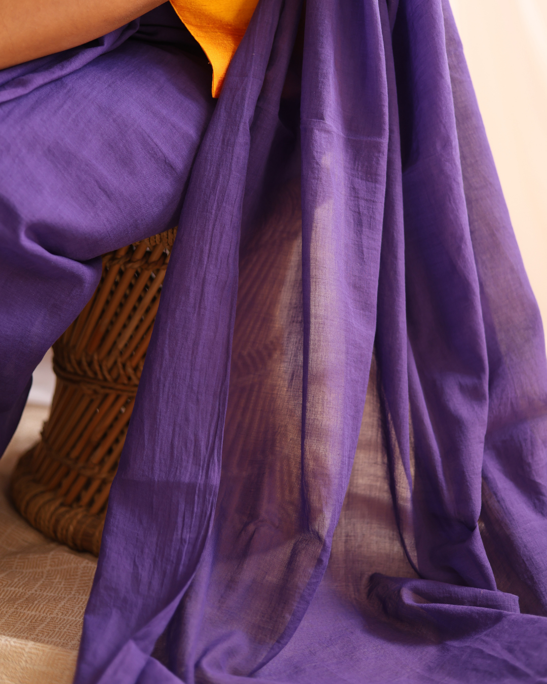 A close-up view of the Galaxy solid purple handloom cotton saree showcasing its soft, sheer drape and natural texture. Crafted by skilled artisans using traditional weaving techniques, this lightweight saree blends timeless elegance with everyday comfort, perfect for both casual and festive wear.