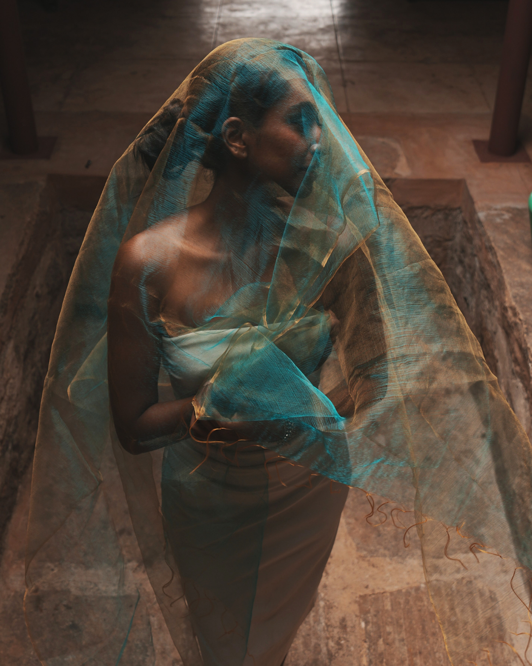 Model draped in a handwoven Bengal silk scarf in ethereal sunburst green with golden undertones, styled as a flowing veil. Crafted with traditional handloom weaving techniques, this lightweight, breathable scarf merges heritage craftsmanship with contemporary luxury.