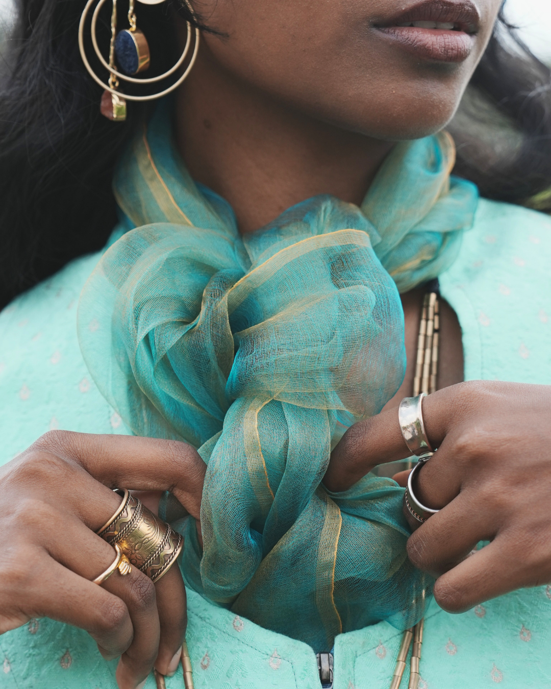 Handwoven Bengal silk scarf in sunburst green with fine golden accents, styled in a soft gathered knot. Lightweight and airy, this traditional silk scarf is crafted using age-old weaving techniques, blending heritage craftsmanship with modern everyday elegance.