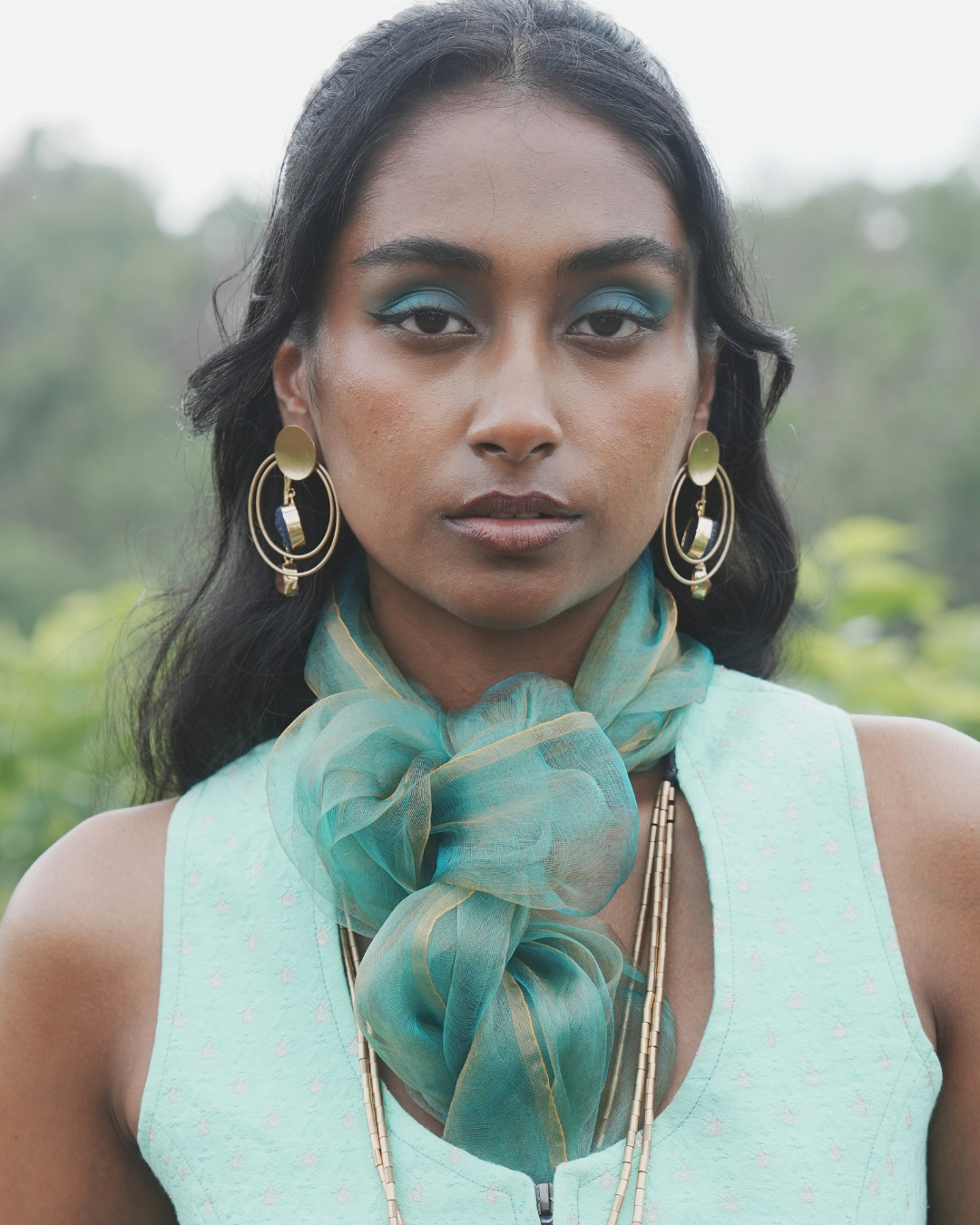 Handwoven Bengal silk scarf in sunburst green with soft golden tones, styled in a floral knot. Lightweight, airy, and colour-shifting, this artisanal scarf is crafted using traditional weaving techniques for a timeless look.