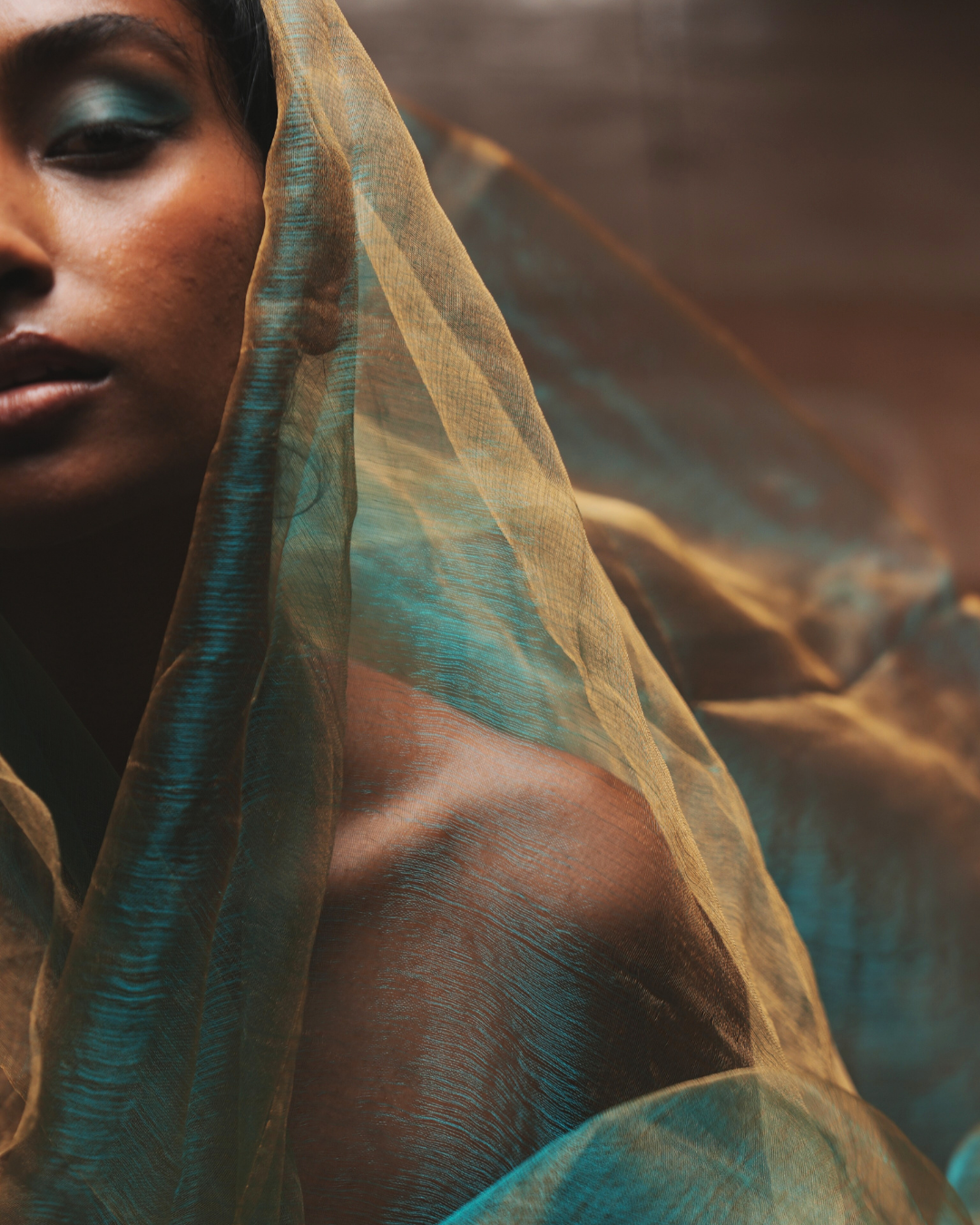 Handwoven Bengal silk scarf in sunburst green with delicate golden threads, styled as a soft drape over the shoulder. Lightweight, breathable, and crafted using traditional weaving techniques, this colour-shifting silk scarf blends heritage craftsmanship with a modern look.