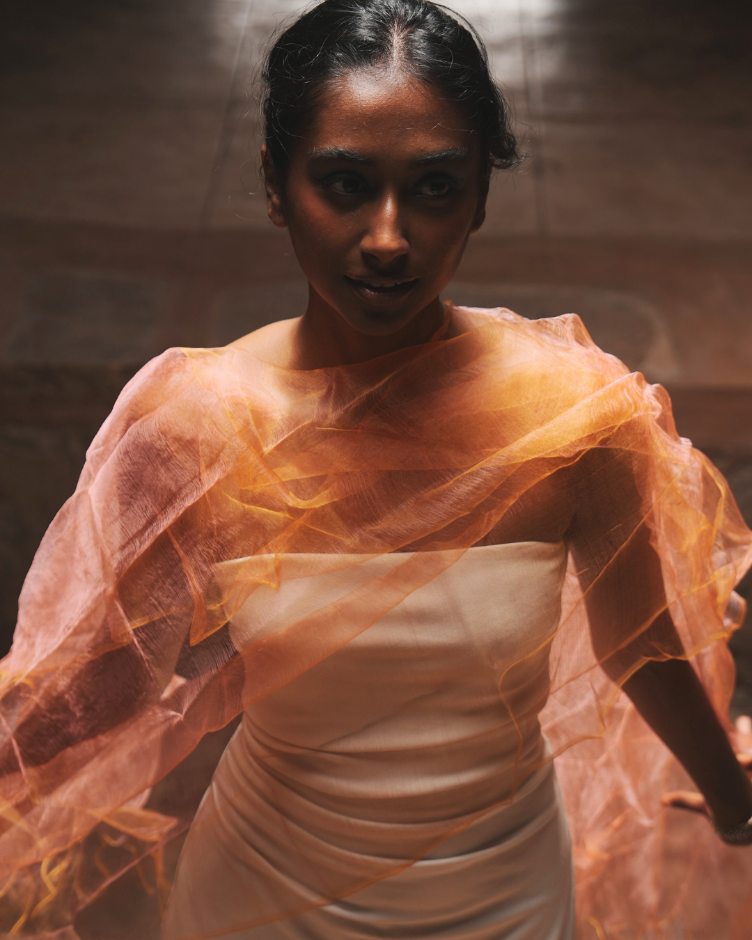 Sunburst Pink luxury handwoven silk scarf draped over a strapless dress – lightweight, sheer, colour-shifting artisan scarf for women, perfect as a statement accessory or premium gift