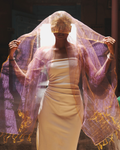 Model draped in the Sunburst Purple handwoven dual-tone silk scarf, glowing in shifting hues of purple and gold. Crafted in Phulia, West Bengal, this is featherlight silk of just 19g.