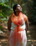 Woman wearing a double colour pink and yellow scarf in a natural setting